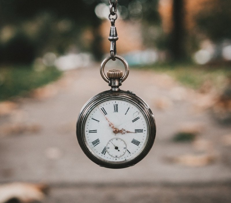 clock hanging from chain