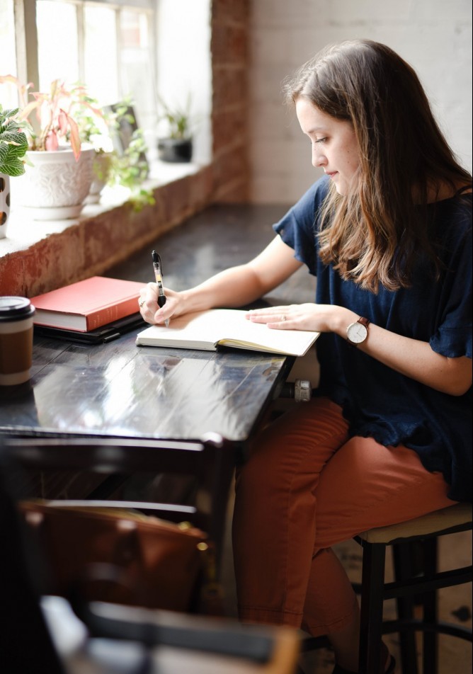 woman working diligently at writing