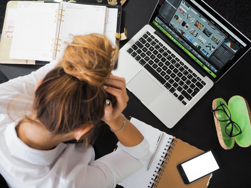 young woman feeling frustrated at computer