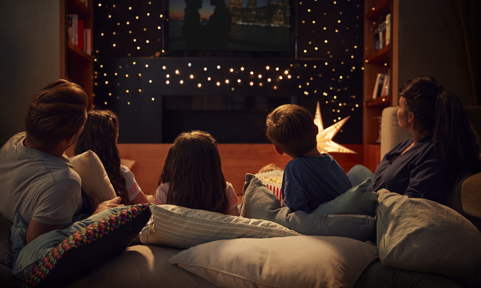 Family Enjoying Movie Night At Home Together