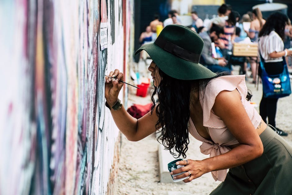 Woman painting a mural