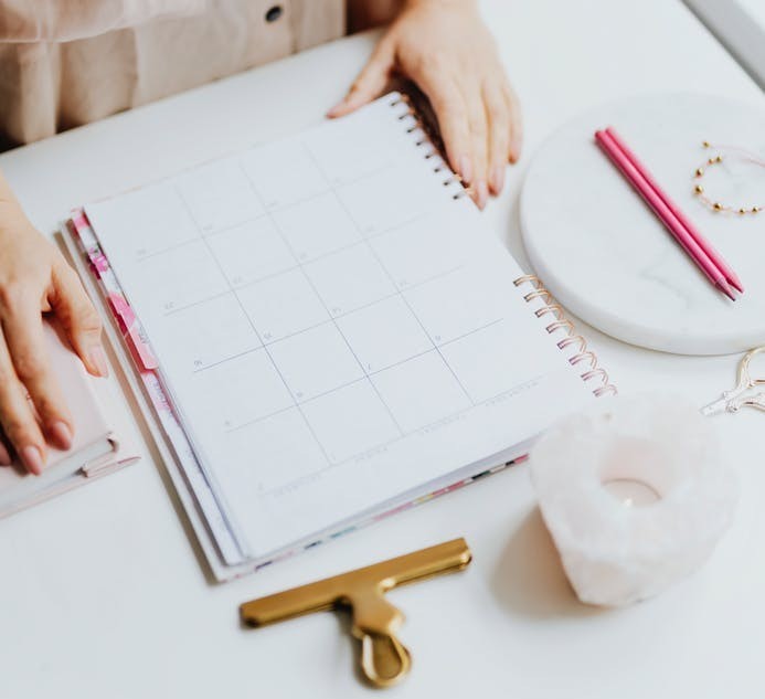 day planner on desk with candle