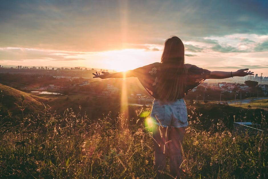 happy woman watching a sunset