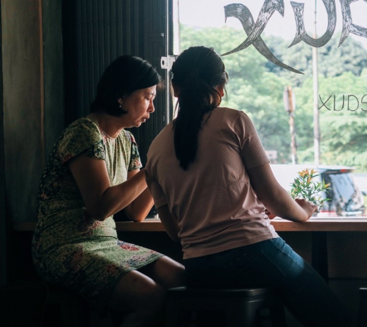 two asian woman sitting together