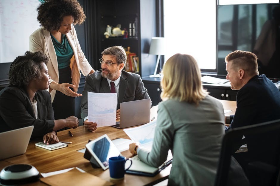 woman sharing report with executives in office