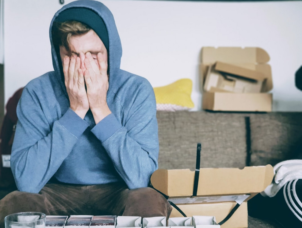 overwhelmed man in messy apartment